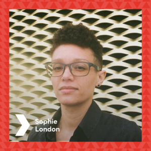 Photograph of Sophie London in front of the Brixton House gold ventilation wall